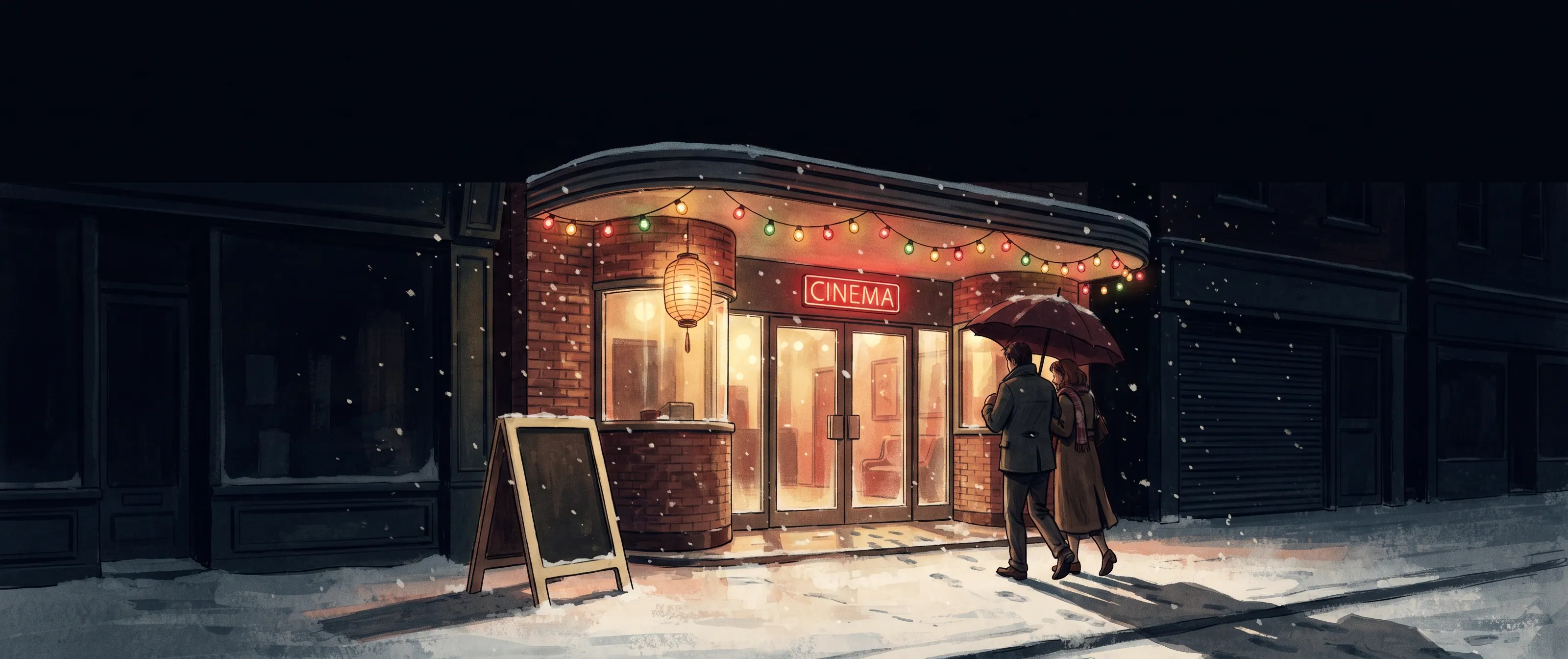 A small cinema lit up on a snowy street at night, festoon bulbs strung along its canopy and a couple walking towards the doors under an umbrella.